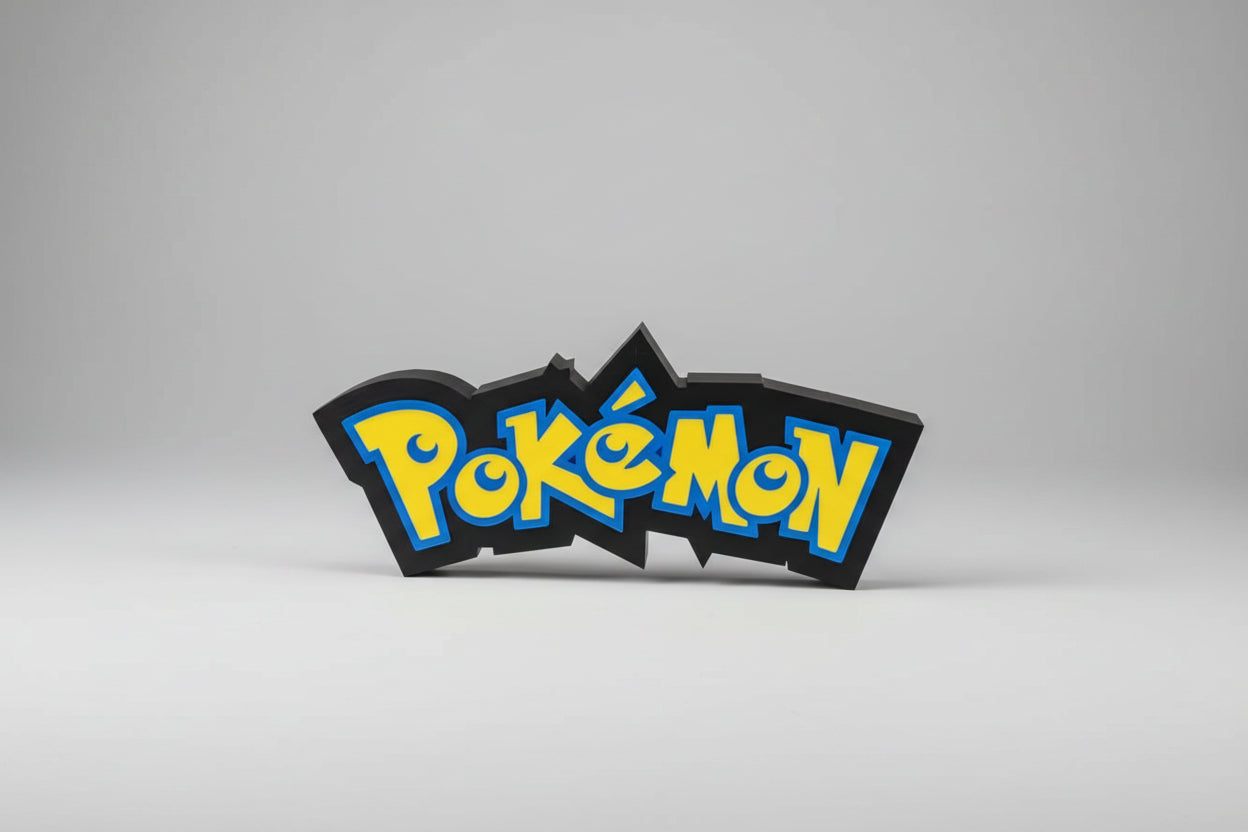 Pokémon logo on a circular metal object with visible wires in the background