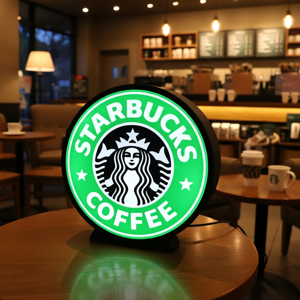 Starbucks Coffee logo on a round green sign with a black border.